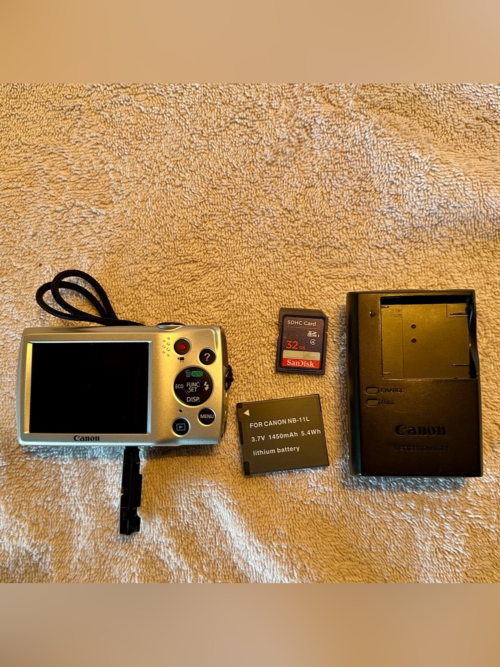 Canon silver compact digital camera with SanDisk 32GB card and NB-11L battery